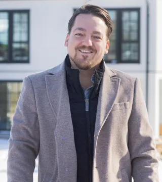 André Schill framför sitt nya hus på Möckelö Strand, Åland.